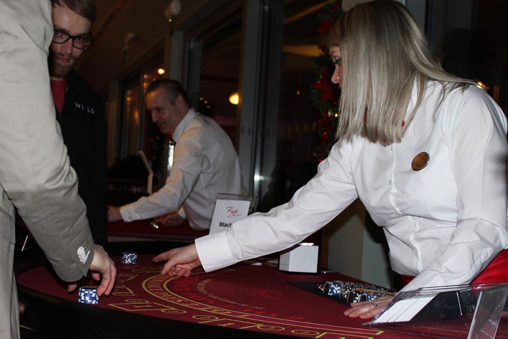 Croupier dealing blackjack at fun casino party night