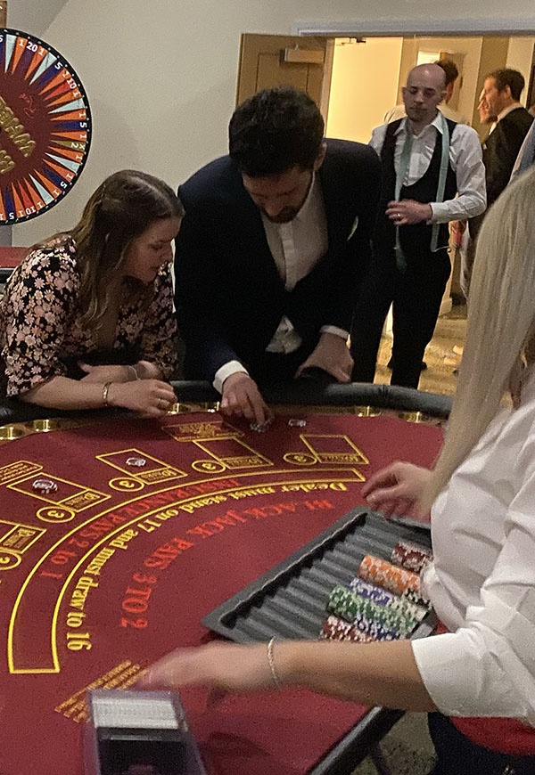 Guests playing blackjack at fun casino party night