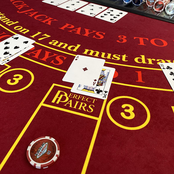 Close up of blackjack cards and chips on table