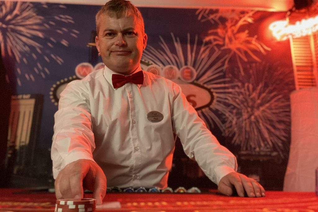 Fun casino croupier wearing uniform of bow tie and name tag