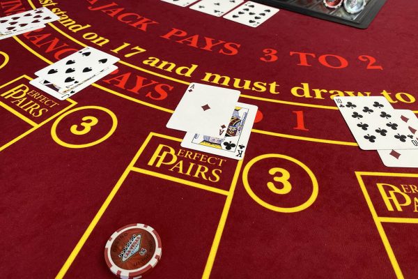Close up of blackjack table, showing casino chips and cards