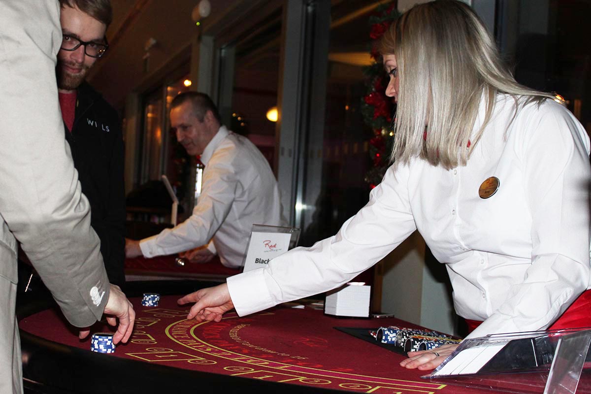 Croupier dealing blackjack at fun casino party