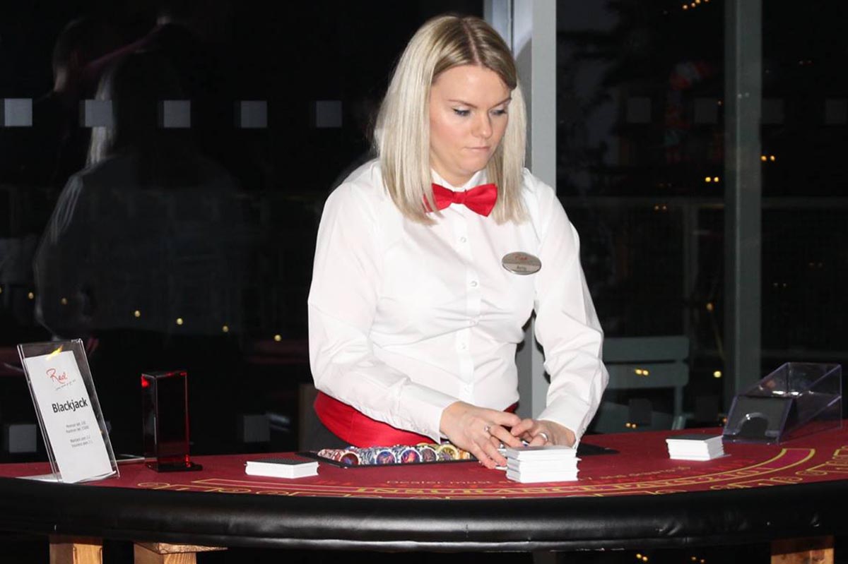 Female at card table wearing red bowtie and name tag