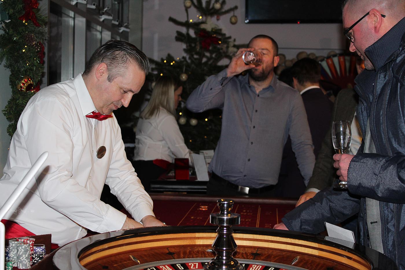 Croupier dealing roulette at a corporate Christmas party