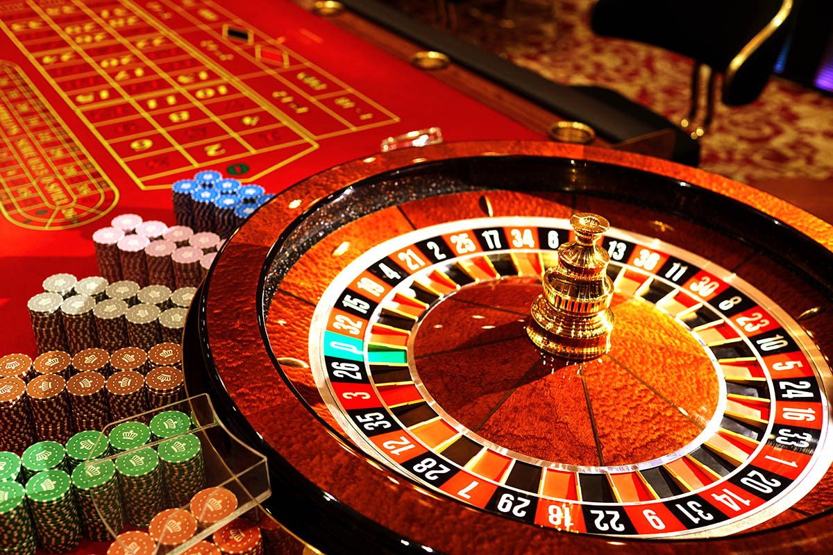 Roulette wheel, table and colour chips. The table is red in colour.